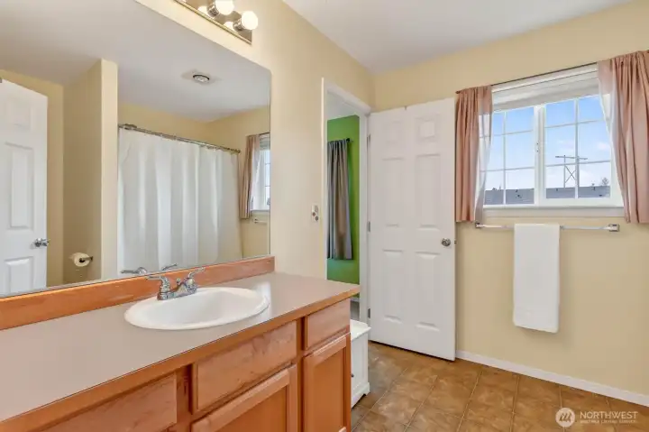 A well-sized Jack-and-Jill bathroom with plenty of counter space to accommodate busy mornings.