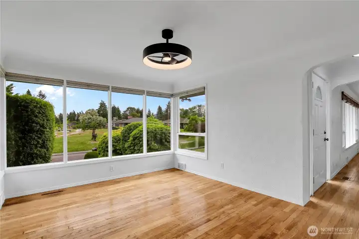 Dining room with hardwood floors, updated fixtures and fresh paint!