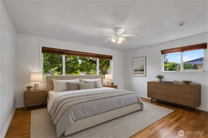 Virtually Staged Primary bedroom on main level with hardwood floors and fresh paint!