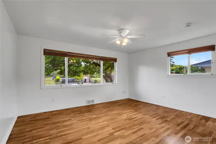 Primary bedroom on main level with hardwood floors and fresh paint!