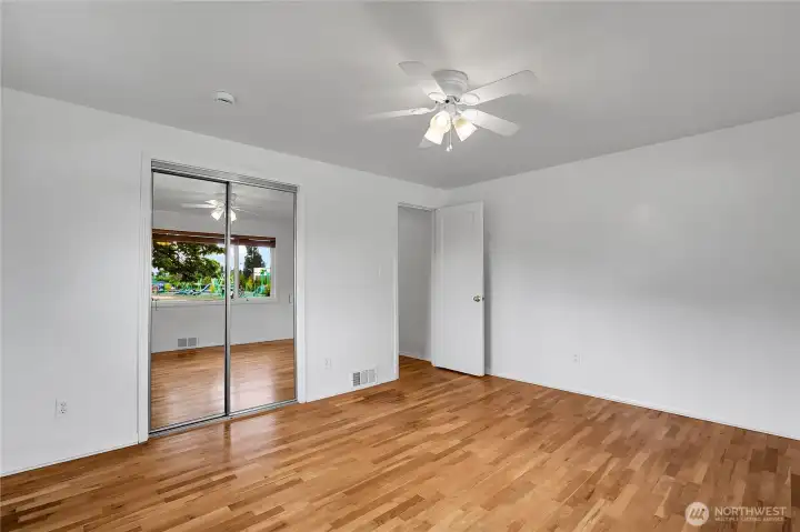 Primary bedroom on main level with hardwood floors and fresh paint!