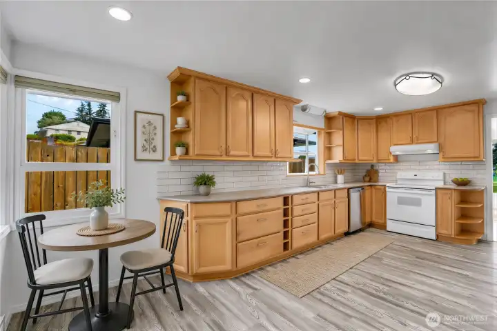 Virtually Staged kitchen on main level with LVP flooring and fresh paint. All appliances stay!