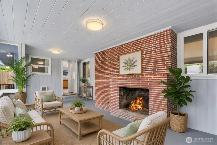 Virtually Staged West facing sun room with wood burning fireplace on main level off back of home