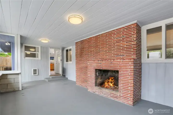 West facing sun room with wood burning fireplace on main level off back of home