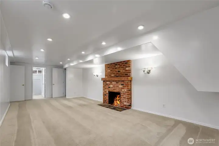 Living room on lower level with wood burning fireplace