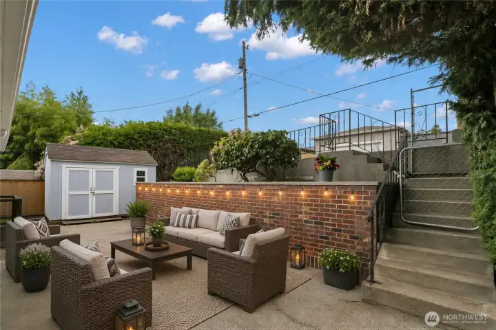 Virtually Staged low maintenance backyard with shed and access to additional parking!