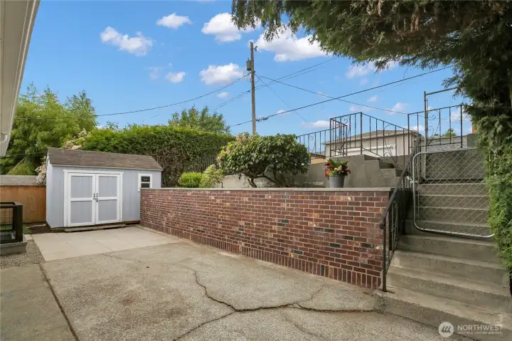 Low maintenance backyard with shed and access to additional parking!
