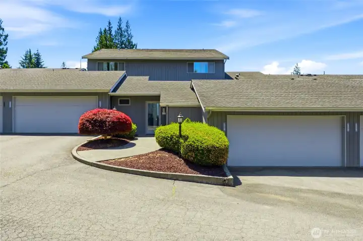 Welcome to Woodland Greens unit #9. Semi-private garage to the right and secure entrance to access the condo.