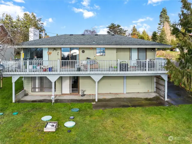 Back of home with multiple patio, deck area outdoor space