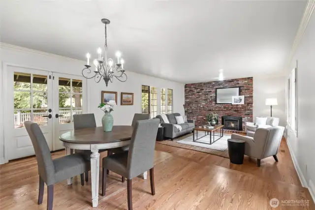 The kitchen is open to the informal dining area and family room. The French doors open to the covered deck and fenced lawn area.