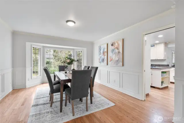 Formal dining overlooks the beautiful yard.