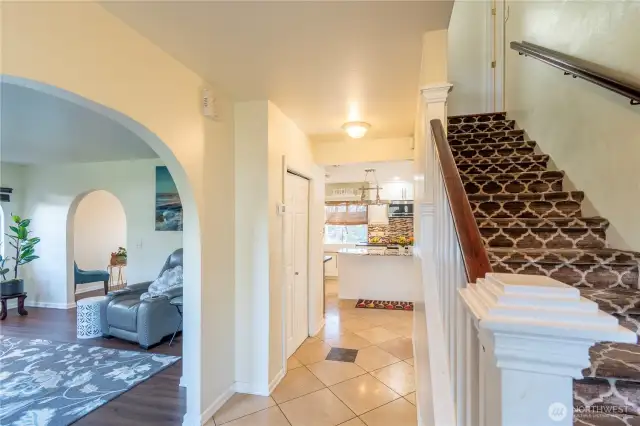 Entry to the home, travertine stone at entrance. Stairs with wood railing up to 4 BD and 2 BA.