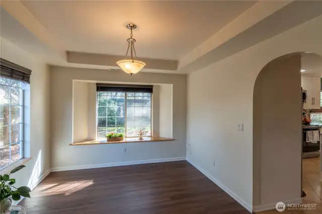 Formal dining room at back of home with views of back yard and gorgeous slate stone wall.