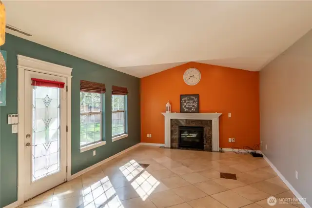 Family room with arched ceiling, mantle with gas fireplace.