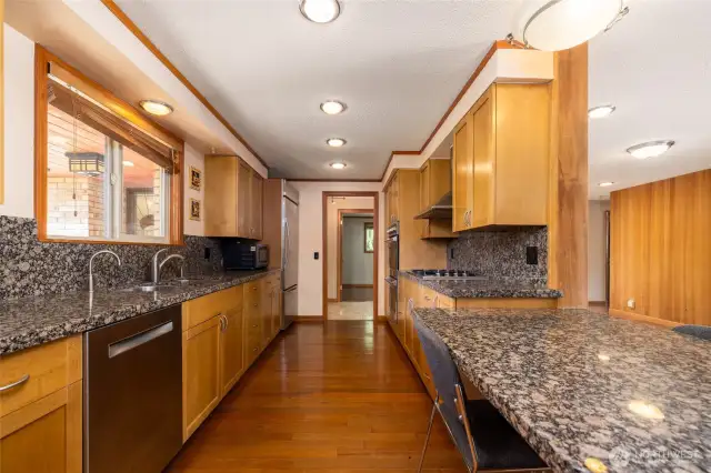Slab granite counters including full backsplash.