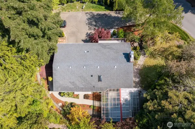 Take it all in from above! The sheer size of that covered back deck is amazing! And see that paved pathway? It's a fantastic feature, connecting both back bedrooms directly to the outdoors and that incredible deck.
