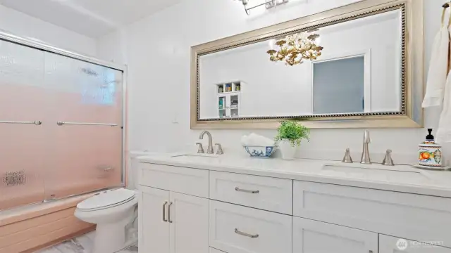 Double the convenience and style in the main bathroom! Featuring a huge, nearly new double vanity and beautiful LVP flooring, updated in 2023.