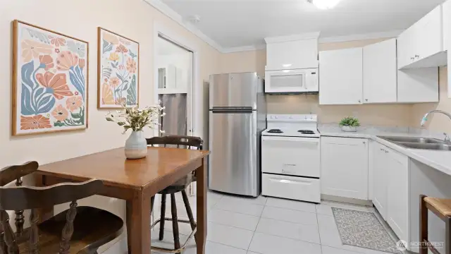 This downstairs kitchen is a winner! It has room for a dining table, and great news – it's dishwasher-ready in that spot by the stool!