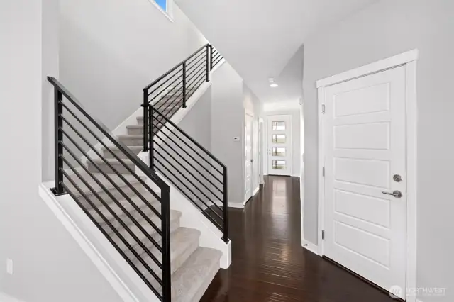Engineered hardwood floors through out the main floor! The hallway from entrance with multiple purpose alcove, powder room, then large under stairs storage and coat closet. Two car garage door entrance across from stairs.