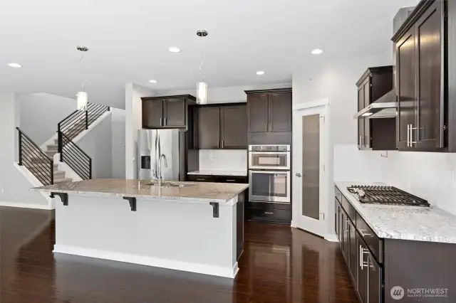 This amazing kitchen has lots of storage in under and above cabinetry, plus the large corner pantry!