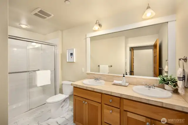 Primary bath includes new flooring, shower door and new toilet.