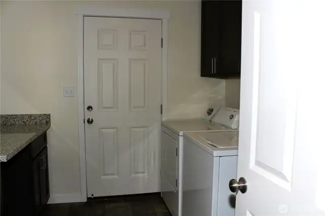 Dedicated laundry room with built in storage!