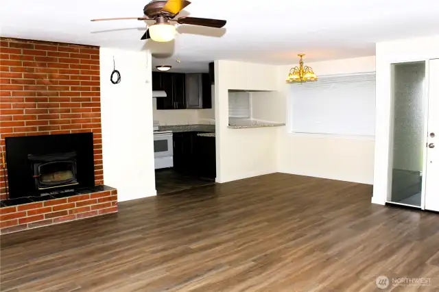 Open and inviting living and dining room with fireplace.