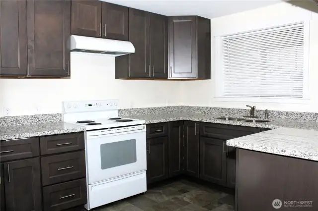 Great kitchen with beautiful granite countertops.