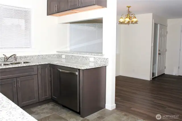 Convenient pass through window to dining room space. Could be utilized as bar seating on the other side potentially as well.