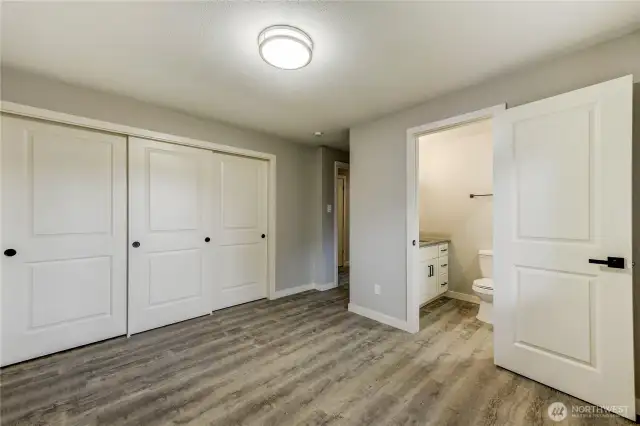 Primary-Fresh paint, modern lighting, and durable vinyl plank flooring create a clean and calming retreat
