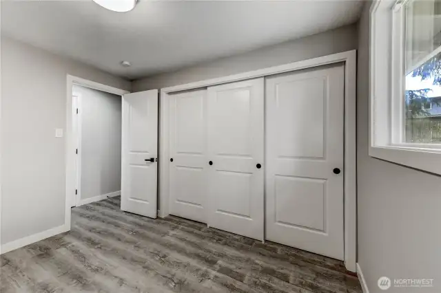 second bedroom featuring wide closets with triple sliding doors