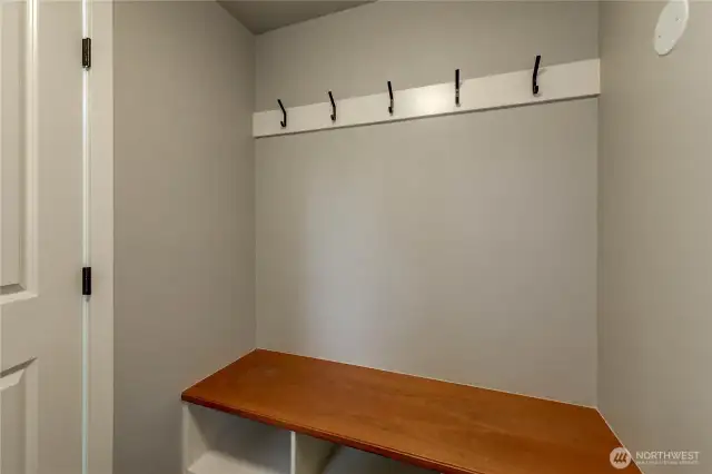 Functional and tidy mudroom with built-in bench seating and convenient wall hooks