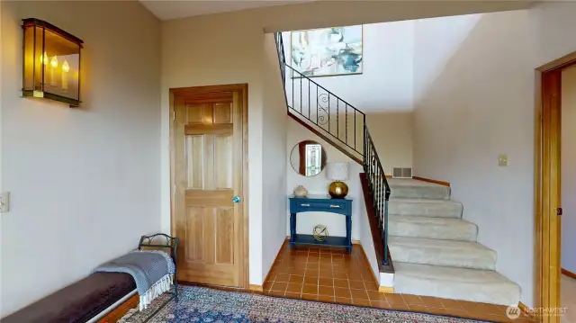 Elegant staircase and warm wood finishes.