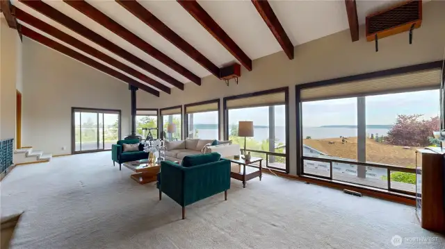 Expansive Family Room with floor-to-ceiling windows fill the space with natural light and showcase Puget Sound.