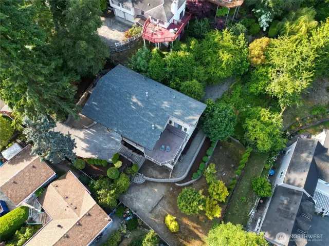 Aerial view showcasing the home’s private setting and terraced yard.