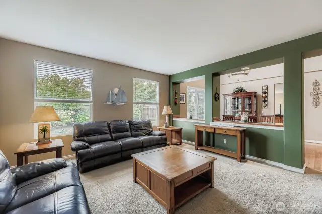 ATTRACTIVE LIVING ROOM IS PERFECT SIZE FOR HOSTING FRIENDS, AND FUN.