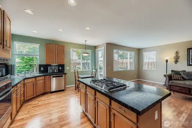 EFFICIENT KITCHEN WITH GAS APPLIANCES, ABUNDANT COUTER SPACE AND STORAGE.