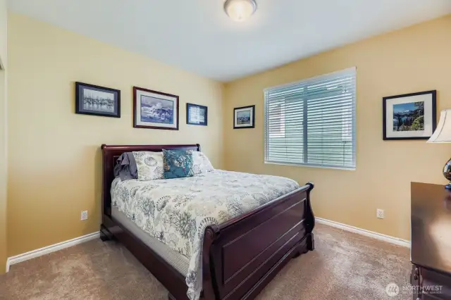COMFORTABLE SECOND BEDROOM UPSTAIRS IS ATTRACTIVE AND BRIGHT.