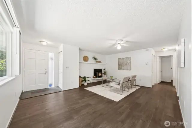 View of living area from kitchen nook.  Wood burning fireplace with insert and fully Tiled mantel