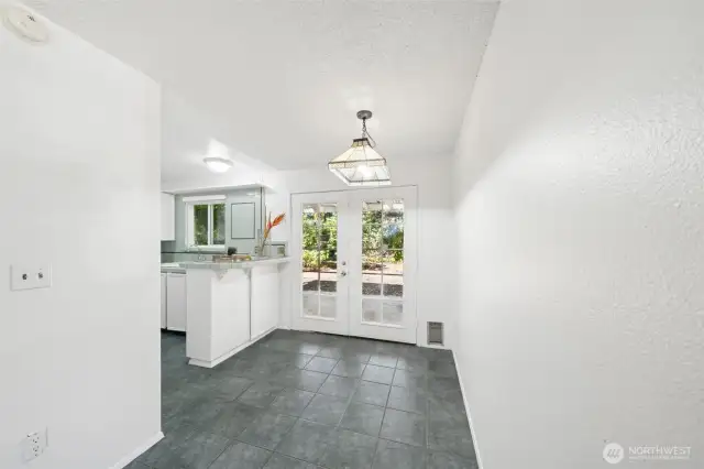 Kitchen nook with french doors that lead to a private covered pateo and yard.