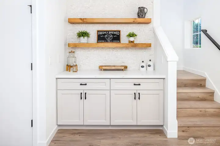 Super cute built in with lots of storage, tiled wall that coordinates with the kitchen and floating shelves.