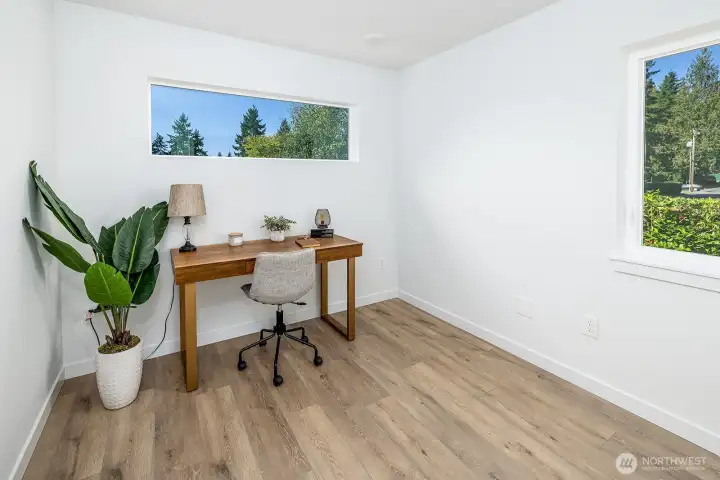 Second of two top floor bedrooms.  Shown here as an office, its ample in size and can easily accommodate a queen bed.  Both windows overlook evergreens.