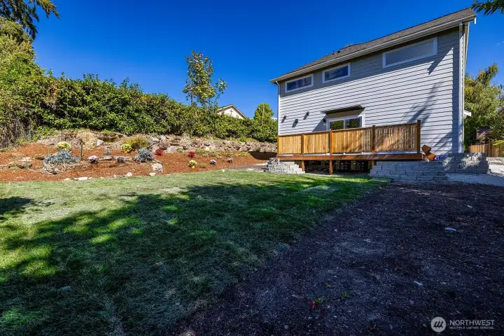 A view from the alley looking east towards the home and expansive deck.