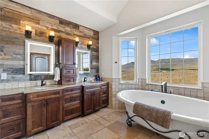 Primary en-suite bathroom with garden tub and dual vanity
