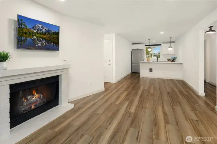 Living room with dining and kitchen - one big space. LVP floors. This is the look from the deck/balcony.