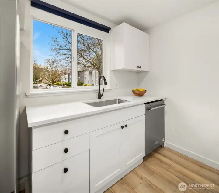 Newly painted kitchen kabinets bright and open, plus new dishwasher and tons of light.