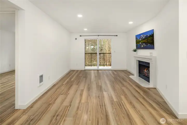 Living room watched from dining room perspective. Curtain rod stays with the purchase of the property.