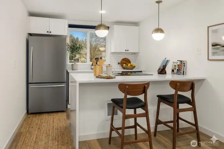 Kitchen with bar area, virtually staged. Kitchen with bar area, virtually staged.