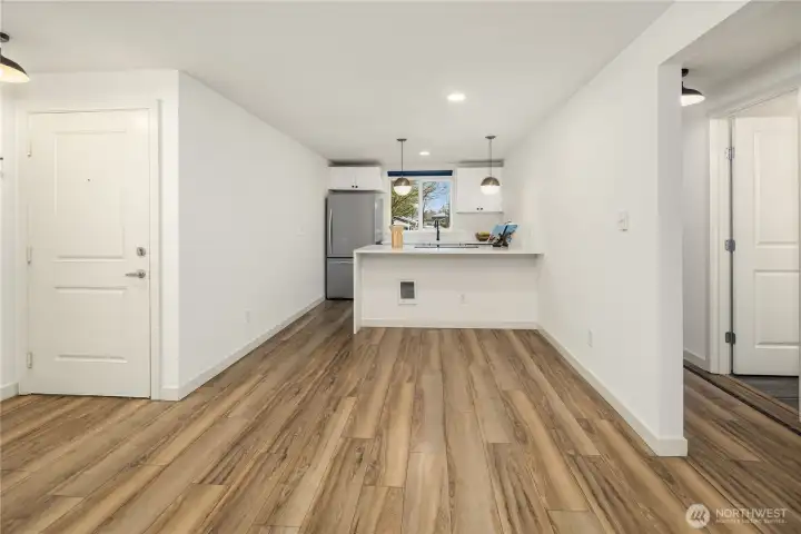 Entrance door leading to open concept living+dining area and connection to hallway that has bathroom positioned between two bedroom. Amazing floor plan!