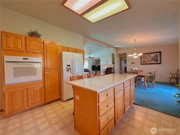 The kitchen features a built-in pantry and a breakfast bar with integrated storage, providing plenty of space to keep everything neatly tucked away.